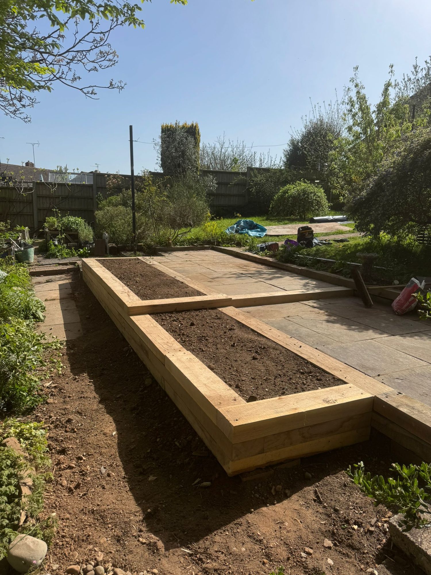 New timber sleeper raised vegetable beds built on a levelled garden plot