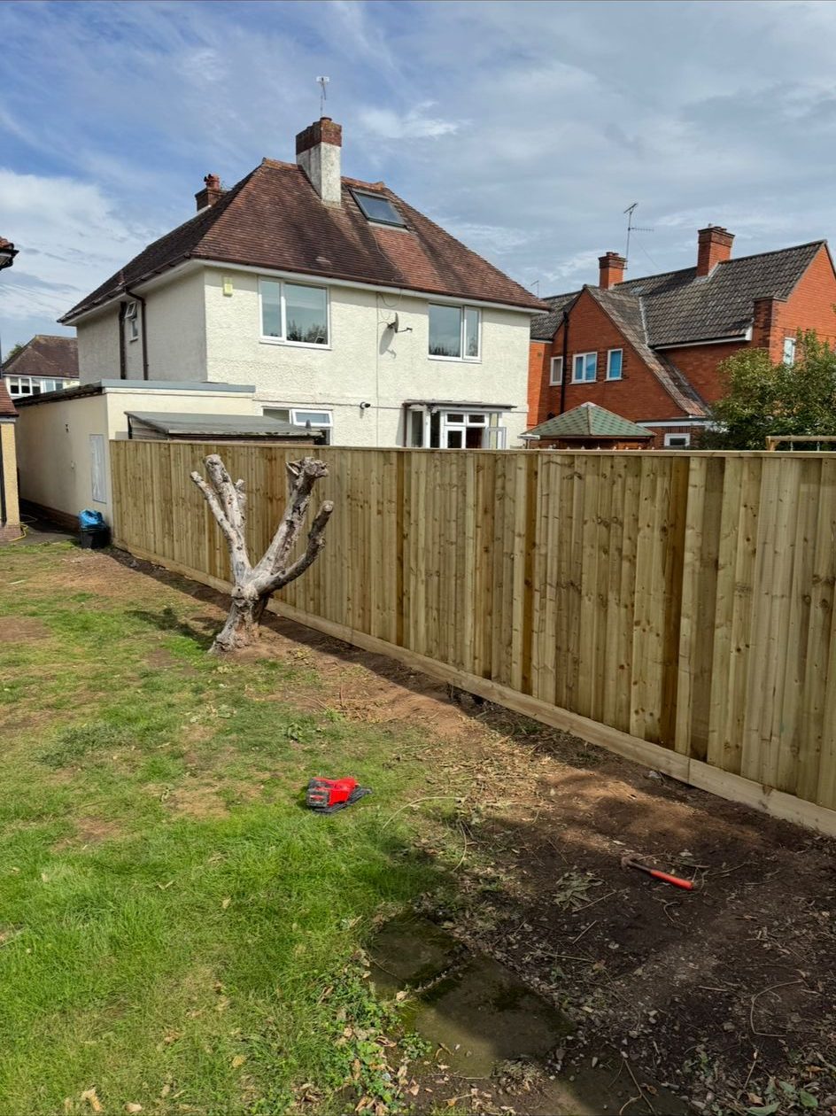 New close board timber fence installed across a rear garden boundary