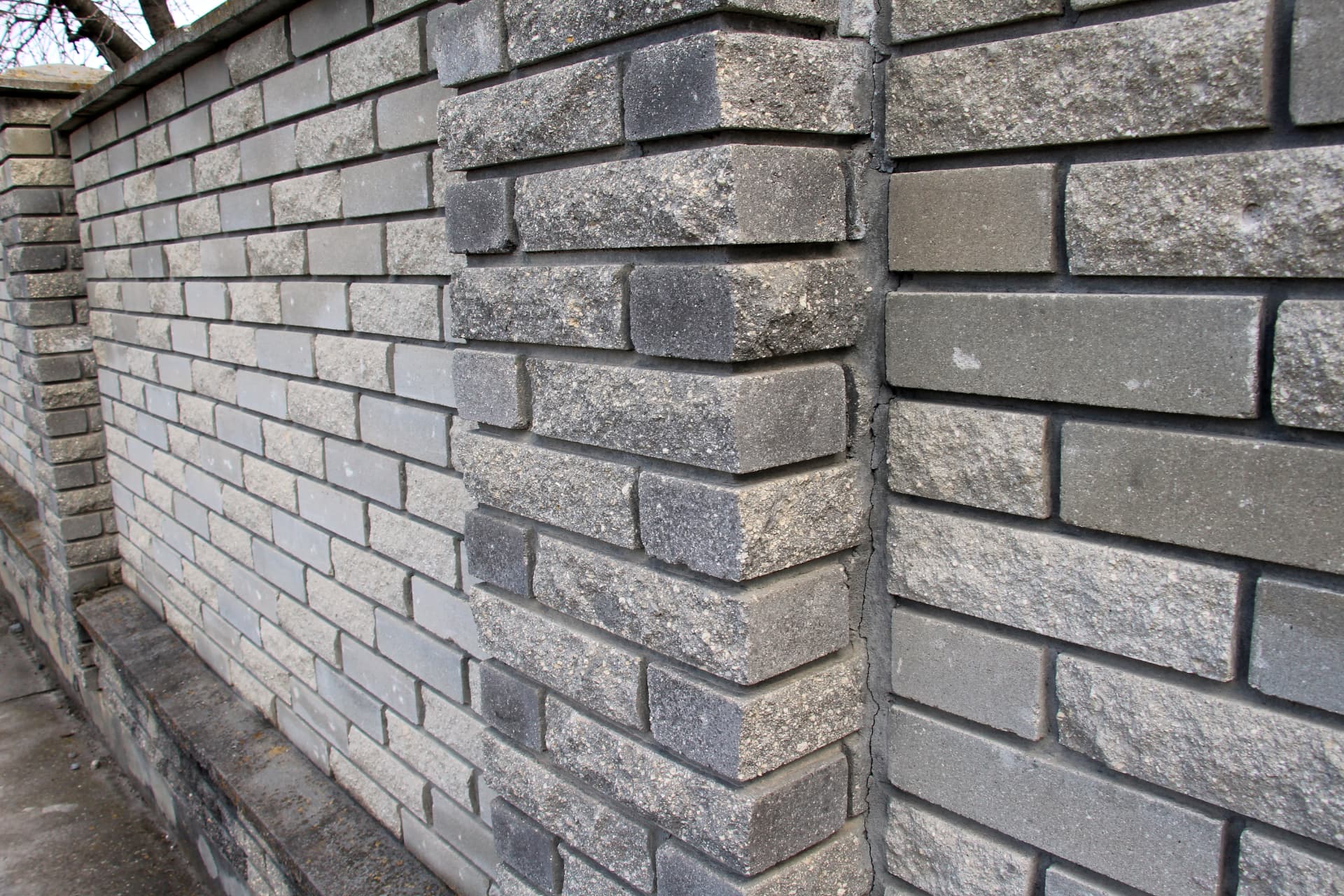 Detail of a stone faced garden wall with crisp mortar joints and feature quoins